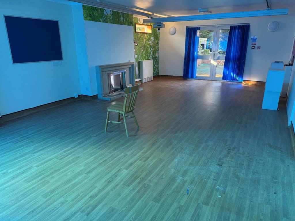 Lot: 87 - FORMER NHS PREMISES WITH POTENTIAL FOR DEVELOPMENT - Day room with doors overlooking rear garden